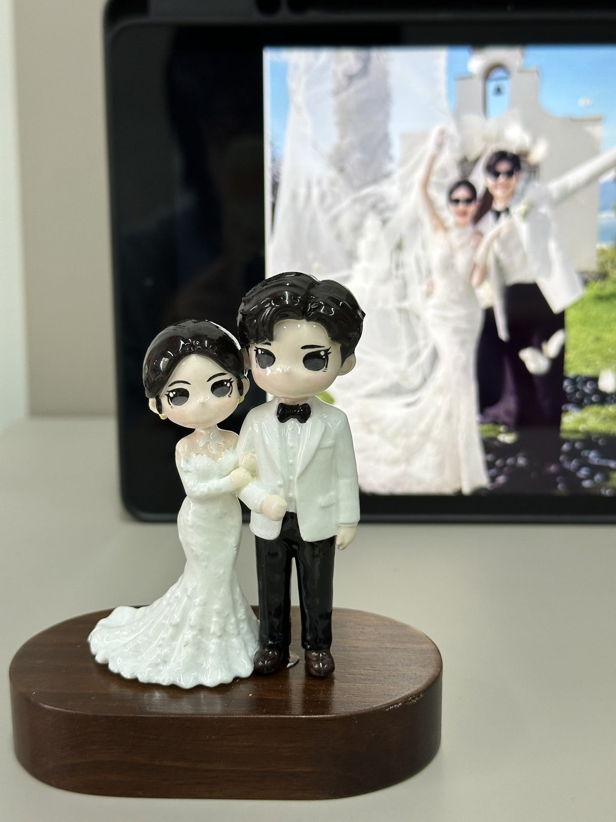 Finished custom wedding couple figurines on a wooden display base